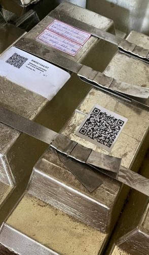 Tin bricks in a pile with Minespider QR codes stuck on them.