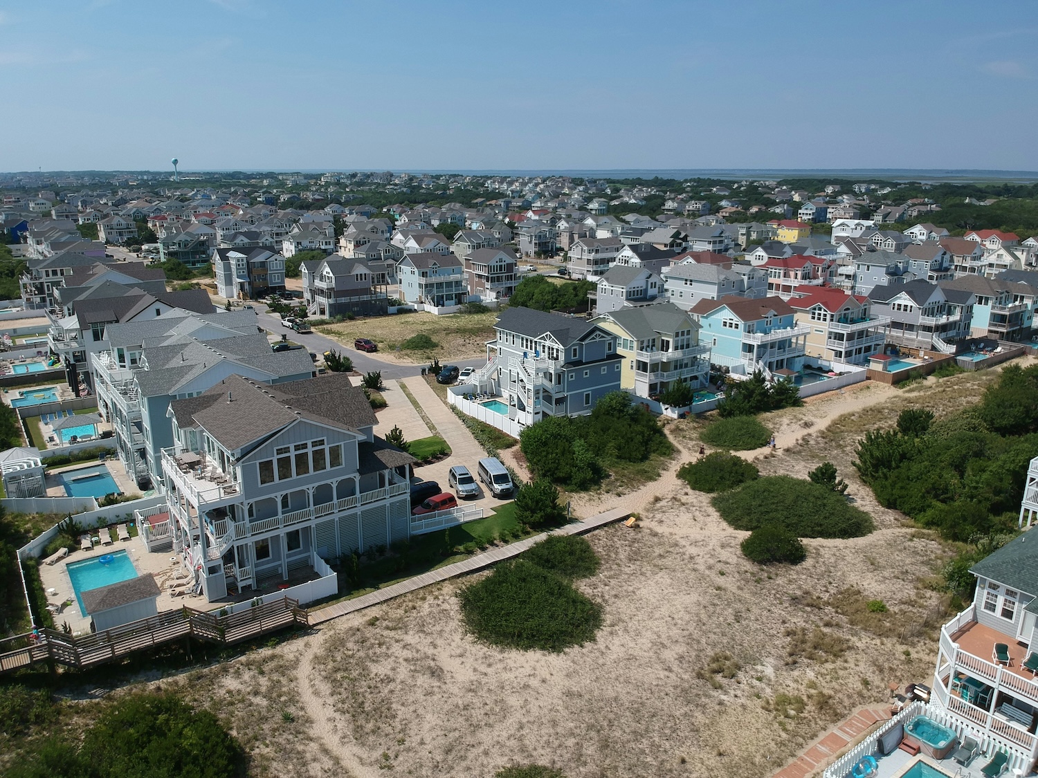 Rows of large colorful homes and vacation rental homes span across one of the islands that make up the Outer Banks.